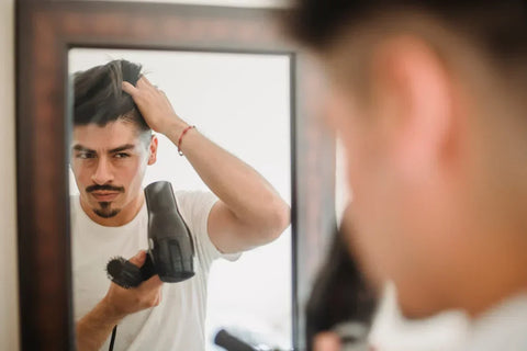 Man styling his hair with hair clay